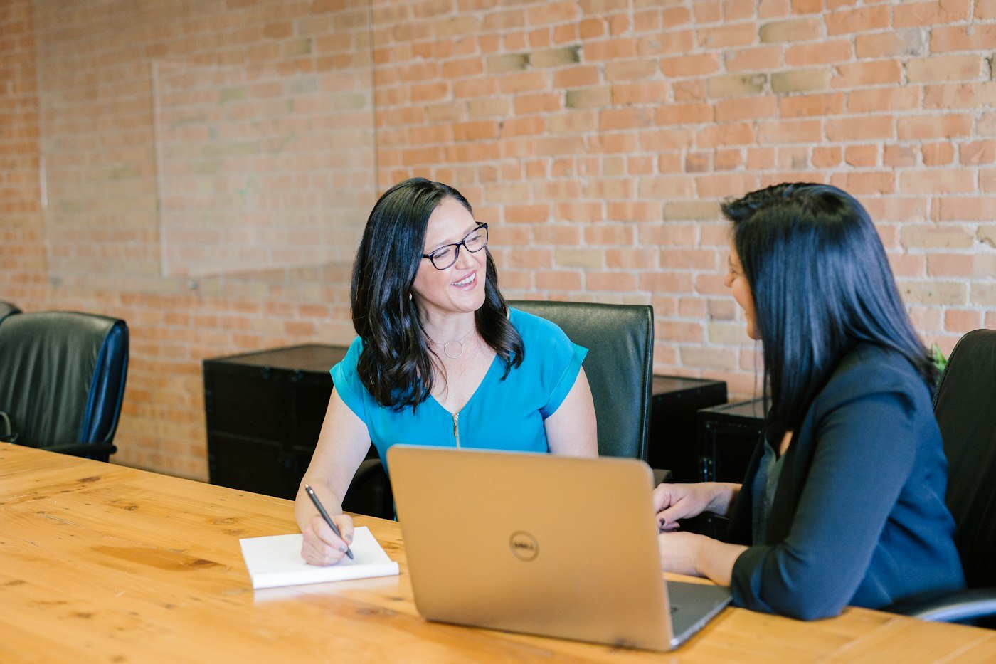 Two professionals reviewing documents together during an insurance consultation